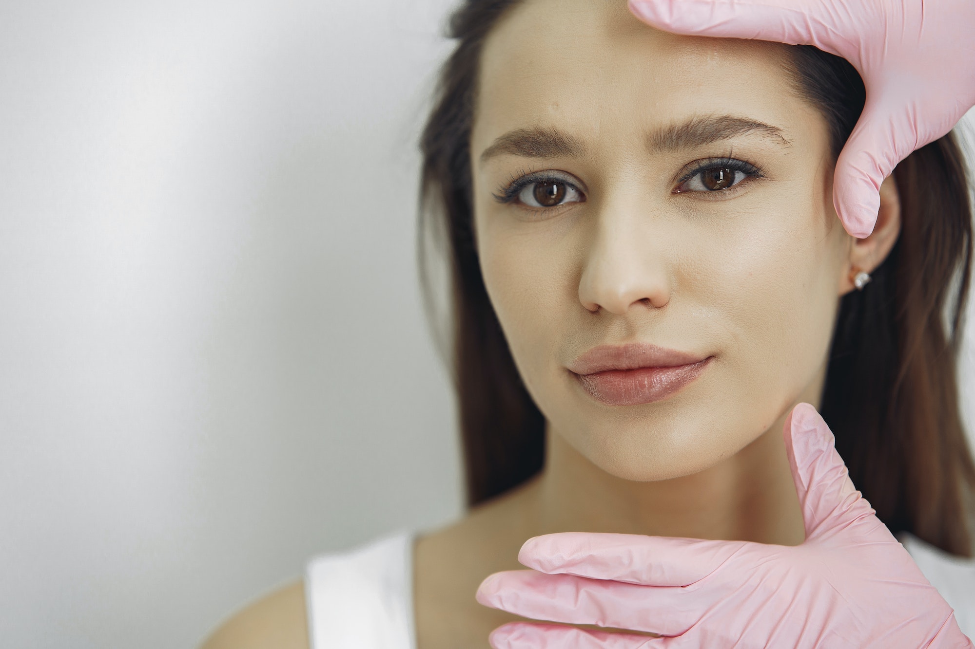 Woman with a doctor in cosmetology studio